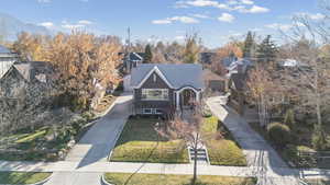 View of front of house with a front lawn and concrete driveway