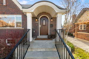 View of exterior entry with brick siding