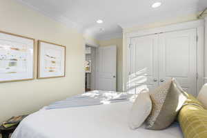 Bedroom featuring ornamental molding, a closet, and recessed lighting