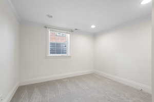 Unfurnished room with ornamental molding, carpet, and recessed lighting