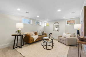 Living room featuring ornamental molding, light carpet, and recessed lighting