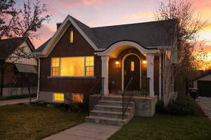 View of front of home featuring a front yard and brick siding