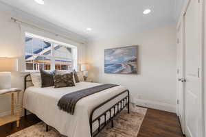 Bedroom featuring ornamental molding, dark wood-type flooring, and recessed lighting