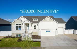 View of front of property featuring driveway, board and batten siding, and a garage