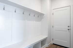 Mudroom with wood finished floors and baseboards