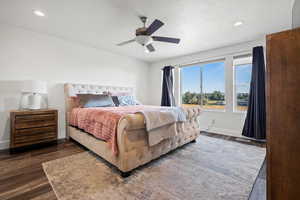 Bedroom with ceiling fan, a textured ceiling, recessed lighting, and dark wood-style flooring