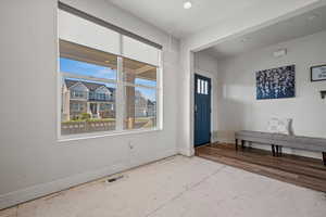 Entryway with baseboards and recessed lighting