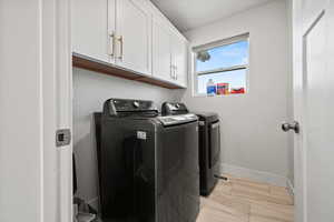 Laundry room with cabinet space and washing machine and clothes dryer