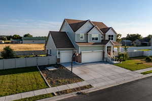 View of front facade with concrete driveway, roof with shingles, a garage, a porch, and a gate