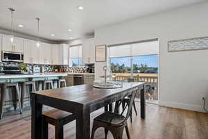 Dining space featuring light wood-style flooring and recessed lighting