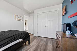 Bedroom featuring light wood-style flooring and a closet