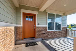 Doorway to property with stone siding