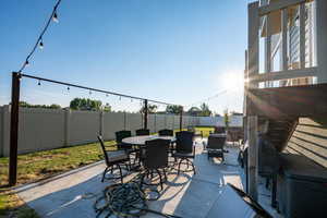 Fenced backyard with outdoor dining area and a patio