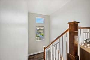 Stairway featuring wood finished floors and baseboards