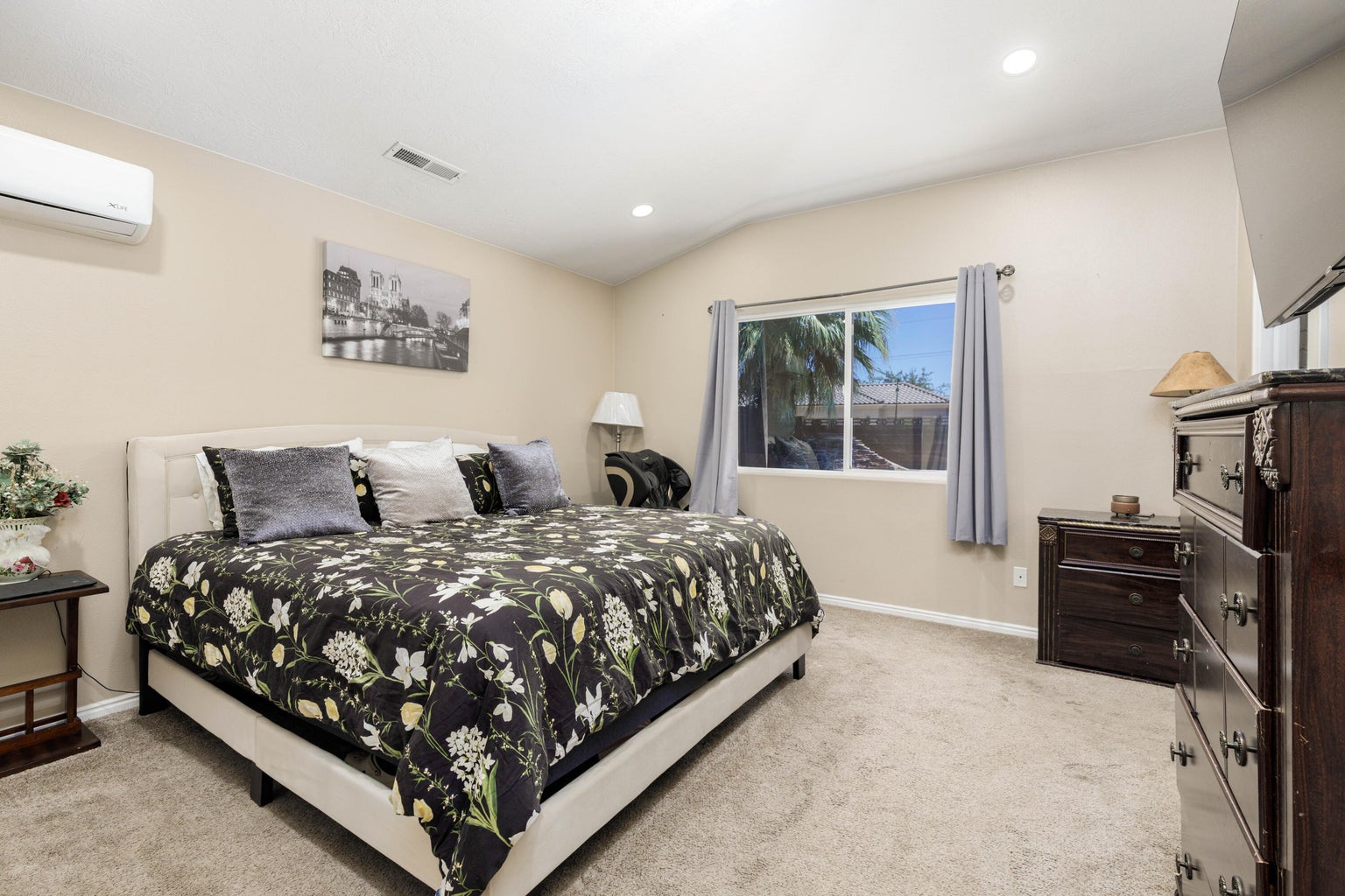 Bedroom featuring light carpet, a wall unit AC, recessed lighting, and lofted ceiling