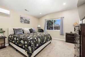 Bedroom featuring light carpet, a wall unit AC, recessed lighting, and lofted ceiling