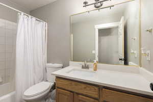 Full bath featuring shower / bath combo and vanity