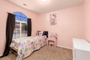Bedroom featuring light colored carpet and baseboards
