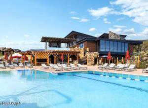 Community pool with a pergola and a patio area
