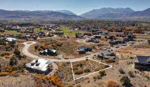 Aerial view of property's location featuring mountains and property parcel outlined