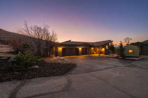 View of front of home with driveway, board and batten siding, and a garage