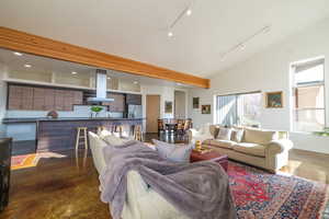 Living room featuring finished concrete flooring