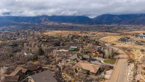 View of property location featuring nearby suburban area and a mountain backdrop