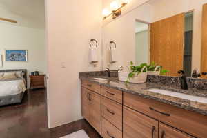 Full bathroom featuring concrete floors and double vanity