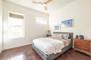 Bedroom featuring a ceiling fan and finished concrete flooring