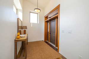 Corridor featuring vaulted ceiling