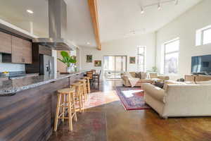 Living area with finished concrete floors, track lighting, and recessed lighting