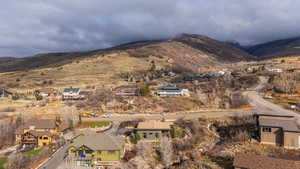 View of mountain backdrop featuring nearby suburban area