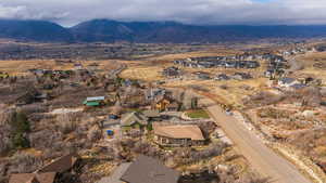 Aerial overview of property's location featuring nearby suburban area and a mountain backdrop