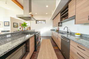 Kitchen featuring light stone counters, island range hood, open shelves, stainless steel appliances, and modern cabinets