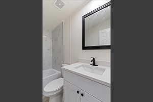 Full bathroom with vanity, tub / shower combination, and a textured ceiling