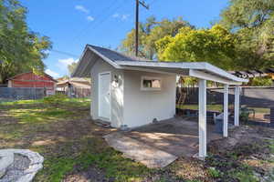View of shed with a fenced backyard