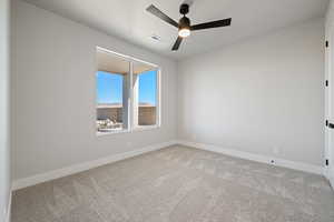 Unfurnished room with light carpet and ceiling fan