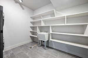 Storage area with stacked washer / dryer and a sink