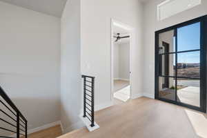 Entrance foyer featuring light wood-type flooring and ceiling fan