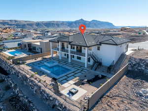 Back of property featuring a patio area, a fenced backyard, a mountain view, and stucco siding