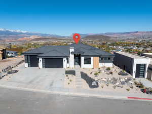 View of front of home featuring a mountain view, a garage, and concrete driveway