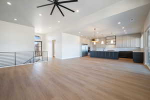 Unfurnished living room with recessed lighting, light wood-type flooring, and ceiling fan