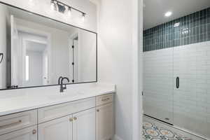 Bathroom with vanity and a shower stall