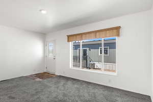 Empty room with carpet floors and baseboards