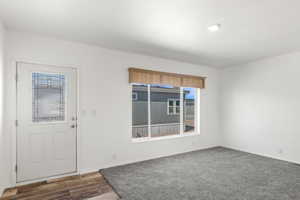 Entryway featuring plenty of natural light and wood finished floors