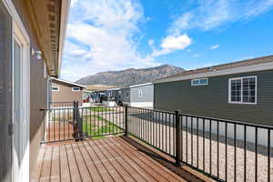 Wooden terrace featuring a mountain view and a residential view
