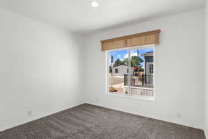 Empty room featuring carpet and recessed lighting