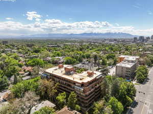 View of urban area with a mountain backdrop and a tree filled landscape