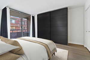 Bedroom featuring light wood finished floors, access to outside, and a closet