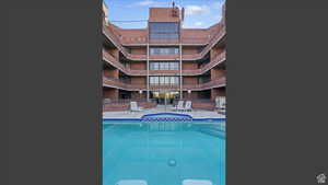 Community pool featuring a patio
